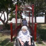 elderly women in wheel chair crossing bridge at sharmar
