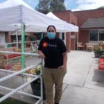 stef at sharmar village wearing black tshirt, khaki pants and a mask